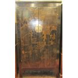 An antique Chinese Qing black lacquered hanging cupboard with gilded chinoiserie detail, the