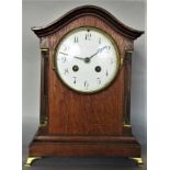 Oak cased Edwardian mantel clock, the convex enamel dial with twin train movement and Arabic