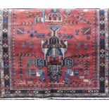 Good old Afshar rug with unusual medallion decoration upon a washed red ground, 210 x 150cm