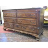 A Georgian oak Lancashire coffer with rising lid, over an arrangement of six long and one short