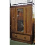 A Victorian partridge wood wardrobe, with central mirror panelled door over a single frieze drawer