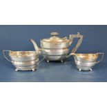 Edwardian silver three piece bachelor tea service comprising teapot, milk jug and sucrier, with