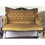 An Edwardian parlour room sofa with carved and moulded show wood frame, with upholstered panels