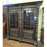 A substantial German oak side cupboard of full height, the front elevation enclosed by two