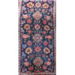 Persian full pile runner with geometric floral decoration upon a navy blue ground with running red
