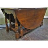 A good quality oak gateleg table with double gate action, raised on turned supports, together with