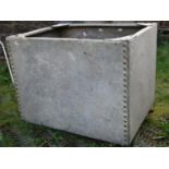 A reclaimed galvanised steel water tank of rectangular form with pot riveted seams, approximately 70