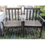 A pair of Firman weathered contemporary hardwood garden open armchairs with slatted seats and backs