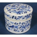 A 19th century oriental blue and white box and cover of circular form flower, bird and insect