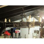 A pair of old English-style iron work hanging ceiling lights of hooped form with repeating pierced