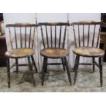 A set of three Swedish stickback kitchen chairs with circular seats together with two Windsor elm