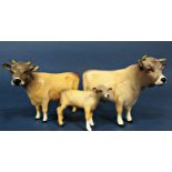 A family of three Beswick Jersey cattle comprising bull, cow and calf (3)