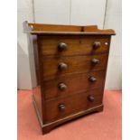 A 19th century mahogany chest of four drawers, 65cm wide, the top fitted with a three quarter