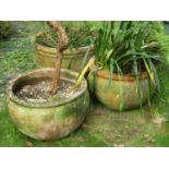 A pair of weathered contemporary terracotta planters with squat circular bowls, 50 cm in diameter