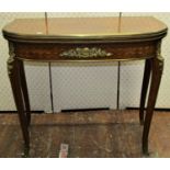 An early 20th century French parquetry D end foldover top card table raised on four shaped and