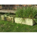 A pair of reclaimed garden planters of rectangular form with foliate detail (planted), 80 cm long