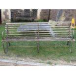 An old park/long garden bench with weathered timber lathes raised on sprung steel supports, (af),