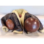 An old vintage leather medicine ball together with a further vintage rugby ball and cricket ball and