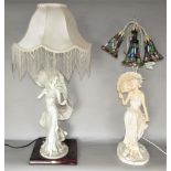 Two figural table lamps in the form of glamourous ladies, one with three leaded glass shades, the