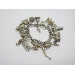 Silver curb link charm bracelet hung with twenty one novelty charms including a mermaid, stamp case,
