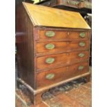 A Georgian mahogany bureau of four long graduated drawers with brass plated handles raised on