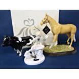 A boxed Royal Doulton model of a palomino pony from the animals series - RDA31, raised on a wooden