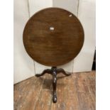A Georgian mahogany snaptop table, the single piece top 73cm diameter, raised on a single gun barrel
