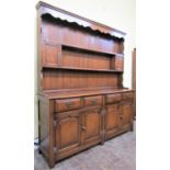 A good quality oak dresser in the 18th century style, the base enclosed by four carved and fielded