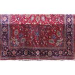 Good large Iranian Hamadan carpet with scrolled blue foliage upon a deep red ground, 400 x 285cm