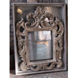 Substantial antique-style mirror in the form of a Rococo frame within a further simple frame with