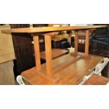 An Arts & Crafts style oak refectory table of rectangular form with cleated ends raised on four
