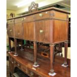 An Edwardian mahogany sideboard enclosed by three drawers and three cupboard doors, raised on