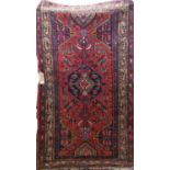 Good Persian rug with central blue medallion framed by intricate floral decoration with geometric
