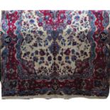 Good quality full pile Meshad carpet with central red and blue floral medallions, framed by