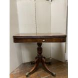 A Regency mahogany D end foldover top tea table raised on a vase shaped pillar and quadruped base