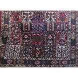 Good full pile Bactia carpet with unusual panelled decoration of various medallions and foliate