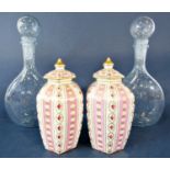 A pair of 19th century continental vases and covers in the Sevres manner with pink striped detail