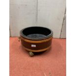 19th century mahogany and brass banded cooler, with brass ring handles raised on three ball and claw