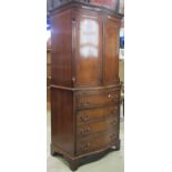 A reproduction Georgian style mahogany cocktail cabinet, the lower section enclosed by three