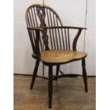 A Georgian Windsor gun back elbow chair in mixed woods, principally elm, fruit wood and yew wood,