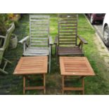 A pair of weathered hardwood folding garden arm chairs with slatted seats and backs together with