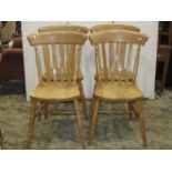 A set of four Windsor style beechwood lathe back kitchen chairs on turned supports