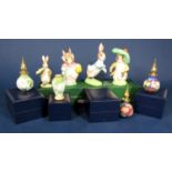 A collection of three boxed Moorcroft enamelled scent bottles and stoppers of various design