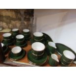 A collection of Apilco green glazed tea and coffee ware with gilt border detail comprising milk