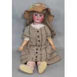 An early 20th century German bisque head doll by Schoenau & Hoffmeister, 1906, mould 15, with blue