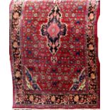 Persian Tabriz rug with central navy blue and pink floral medallion, with geometric floral