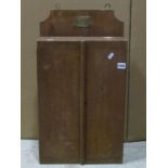 Vintage oak wall mounted chisel cabinet enclosed by two doors, with partially fitted interior with