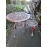 A cast aluminium garden terrace table of circular form with decorative pierced detail together