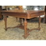 An oak dining table, the rectangular top with pull out end extensions (lacks additional leaves),