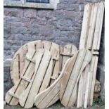 A sturdy and substantial soft wood picnic table with circular slatted top, three kidney shaped bench